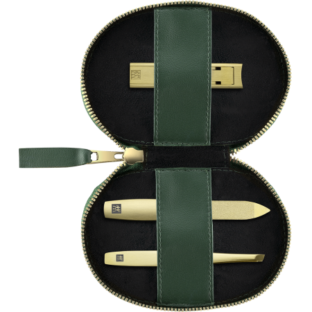 Geöffnetes ZWILLING Premium Apfelleder Set 3tlg. in Grün mit Reißverschluss und essentiellen Pflegeinstrumenten (Kompakt-Nagelknipser, Saphir-Nagelfeile und schräge Pinzette) in matt-gold.