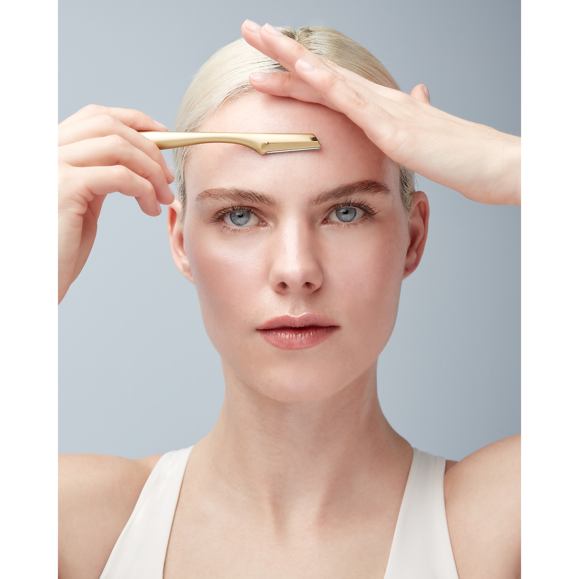 Anwendung eines ZWILLING Premium Gesichtshaar-Rasierers in Gold an der rechten Augebraue.