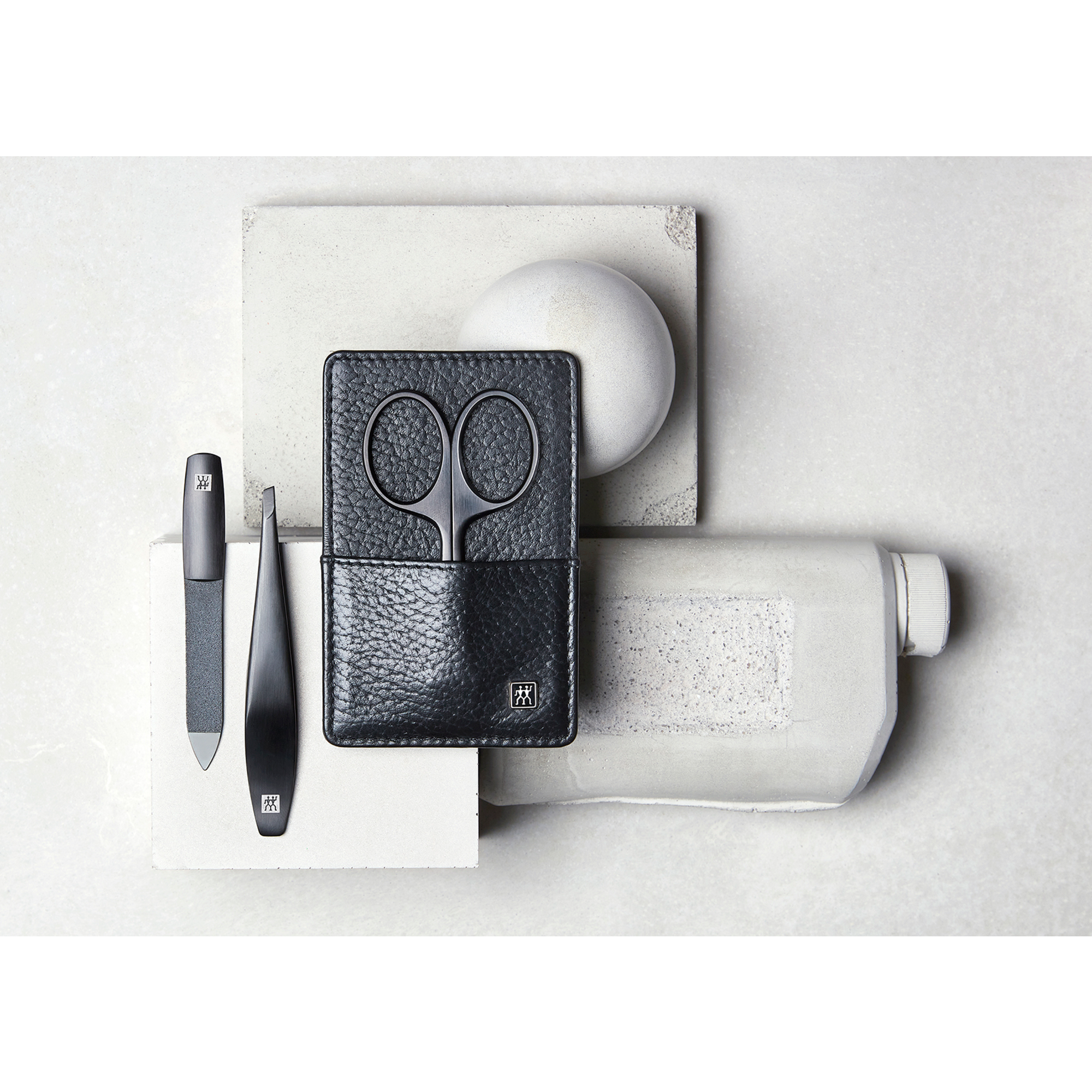 Darstellung eines ZWILLING Premium Maniküre Sets 3tlg. auf artifiziellen Betonobjekten.