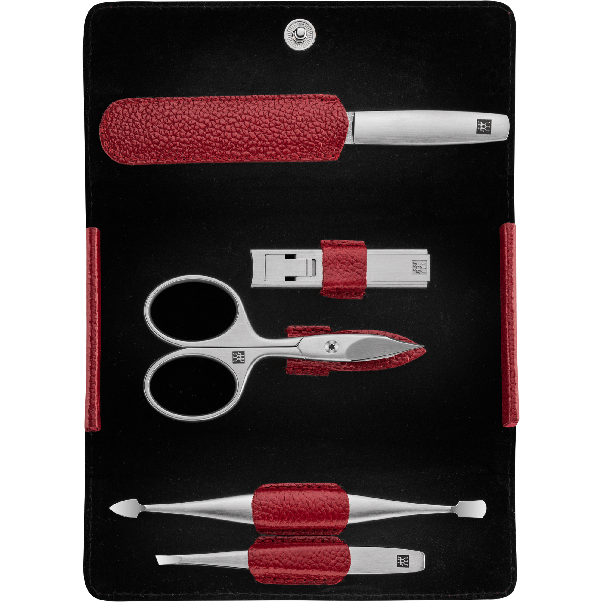 Geöffnetes ZWILLING Premium Maniküre Set 5tlg. in Rot mit Druckknopfverschluss und den meistgenutzten Pflegeinstrumenten aus rostfreiem Edelstahl.