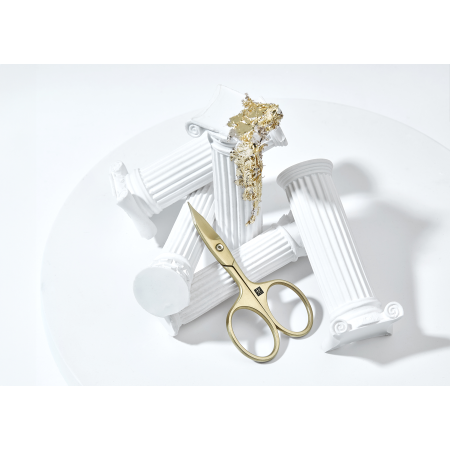 Sehr hochwertige Darstellung der ZWILLING Premium Nagel- und Nagelhautschere inmitten von artifiziellen Marmorsäulen mit Blattgold.