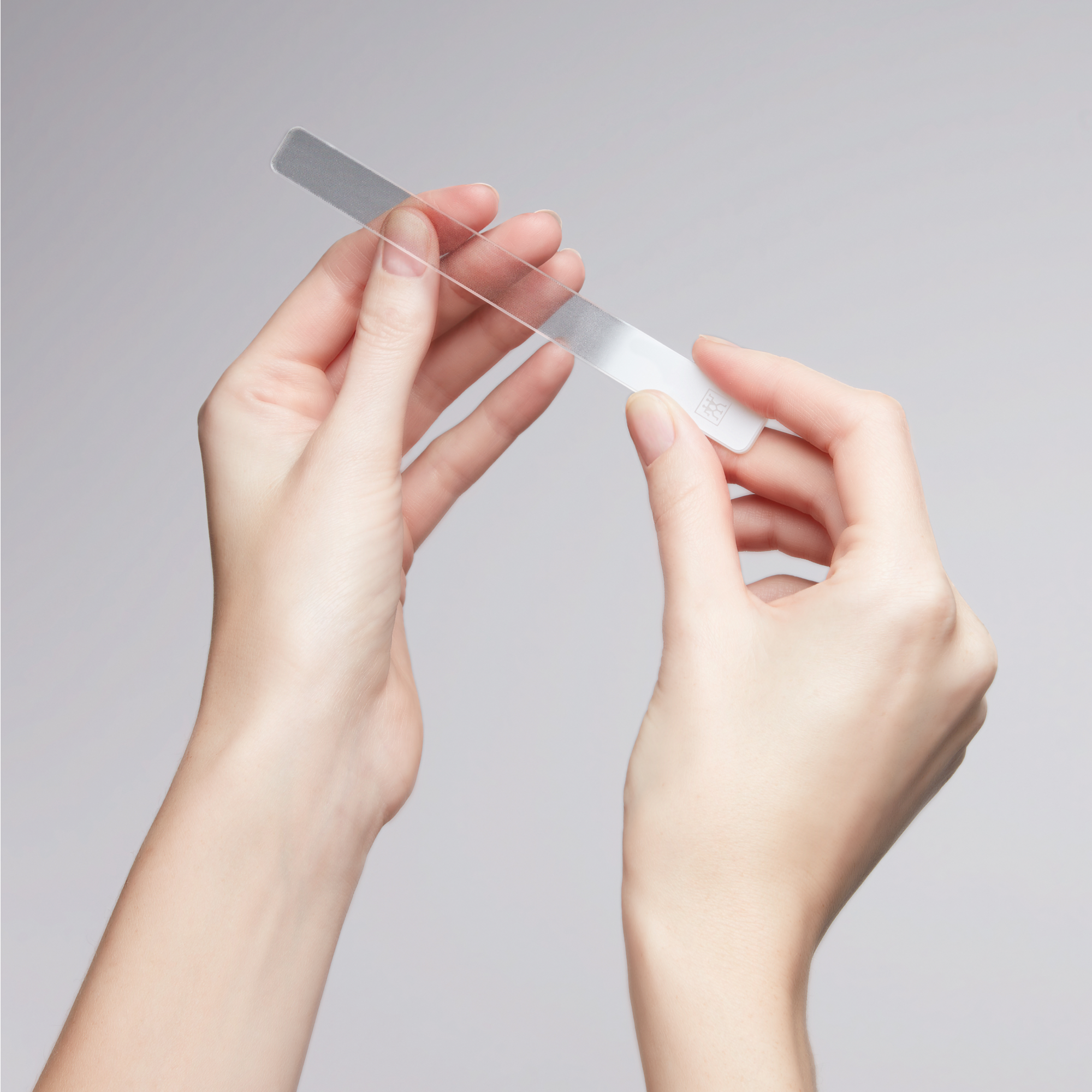 Anwendung eines ZWILLING Premium Glas-Nagelbuffers am linken Daumennagel.