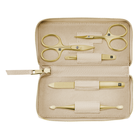 Geöffnetes ZWILLING Premium Set 5tlg. in beige mit den meistgenutzten Pflegeinstrumenten in gold.